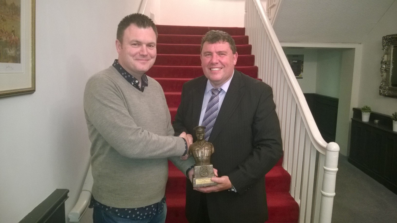 Sergeant Niall Lynch being presented with his AGSI statue by Bernard Clinch